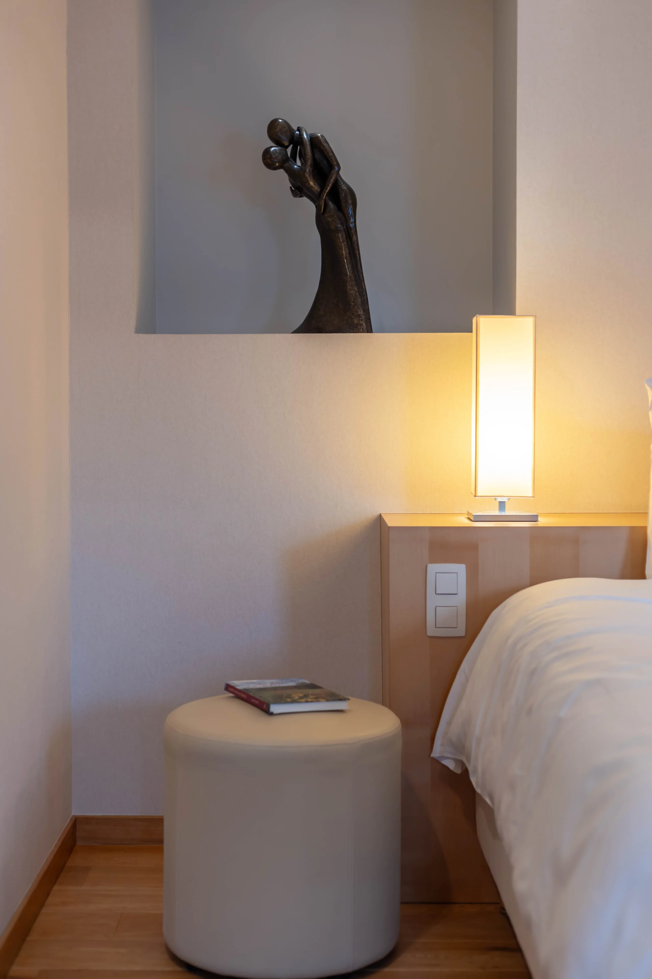 Chambre moderne avec lampe et sculpture élégante.