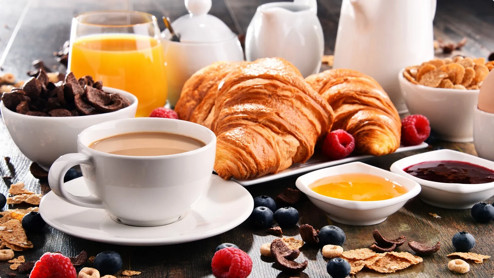 Petit-déjeuner avec croissants et café sur table.