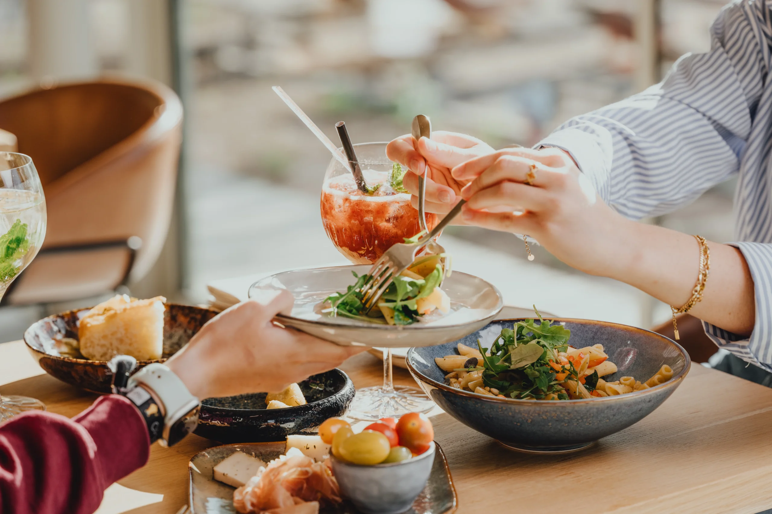 Repas convivial avec salade et cocktail.