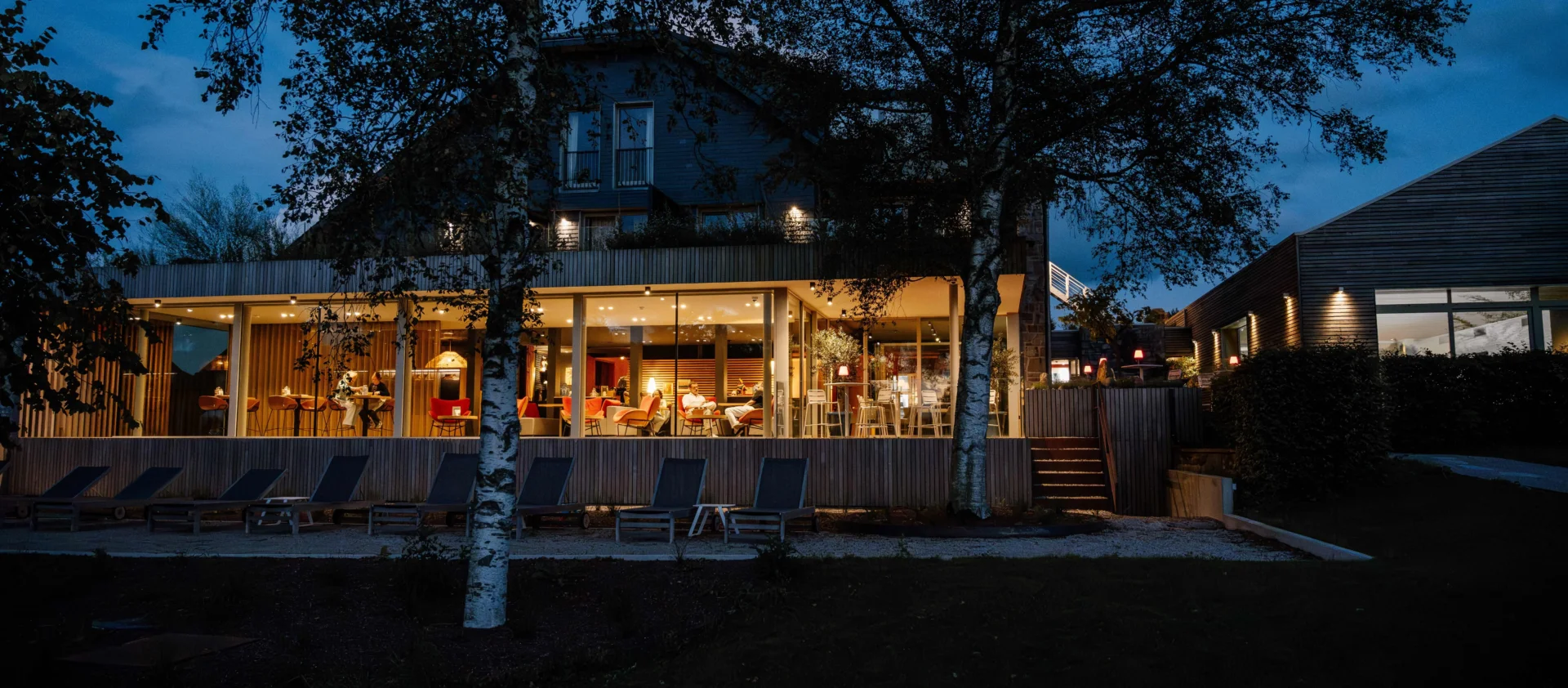 Façade d'une maison moderne illuminée la nuit - Restaurant Gastronomique Ardennes - Robert Hôtels